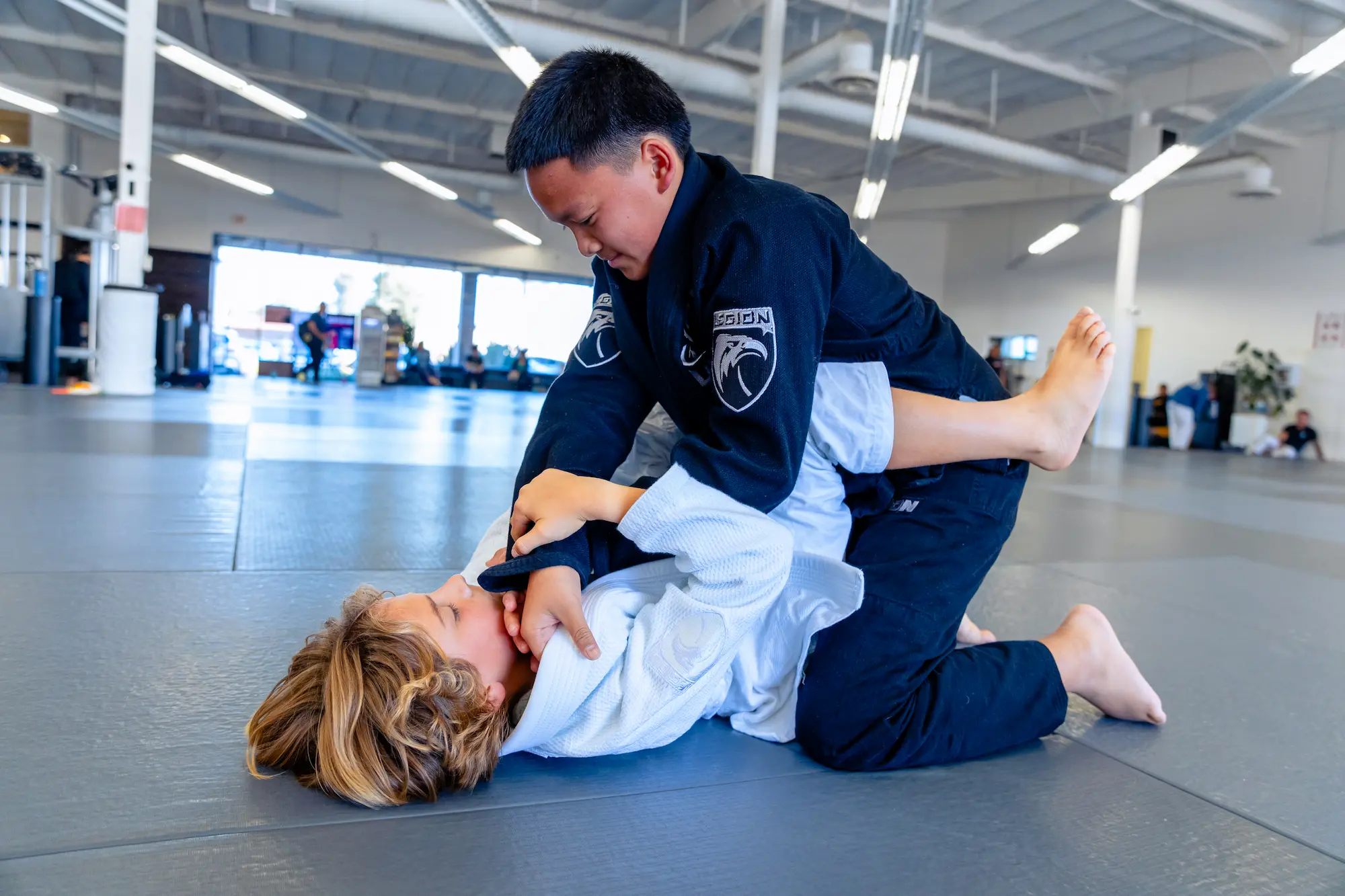 Kids ages 10 to 14 training jiu-jitsu at Legion in San Diego